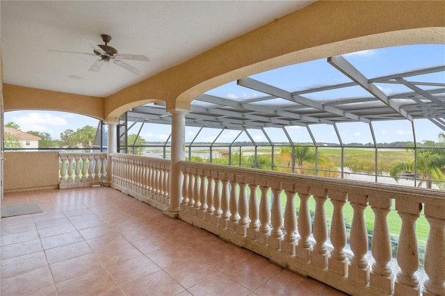 view of patio featuring ceiling fan and a water view