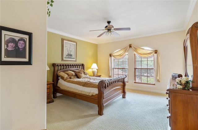 carpeted bedroom featuring ceiling fan and ornamental molding