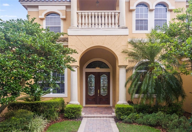 entrance to property with a balcony and french doors