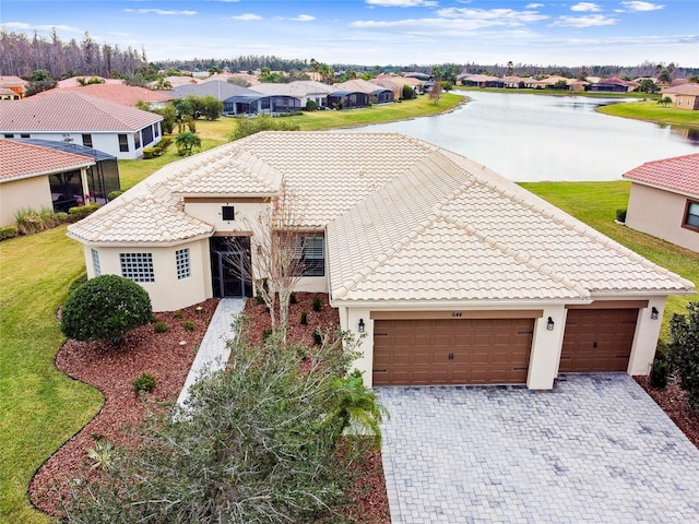 view of front of home with a water view and a garage