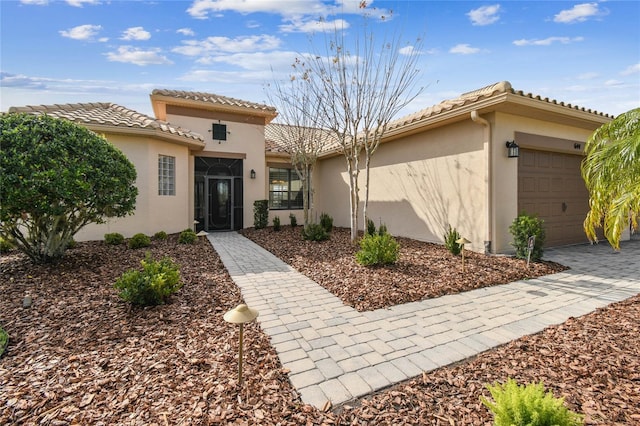 mediterranean / spanish home with a garage