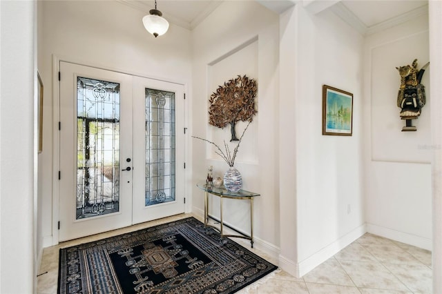 foyer entrance featuring light tile patterned flooring, crown molding, and french doors