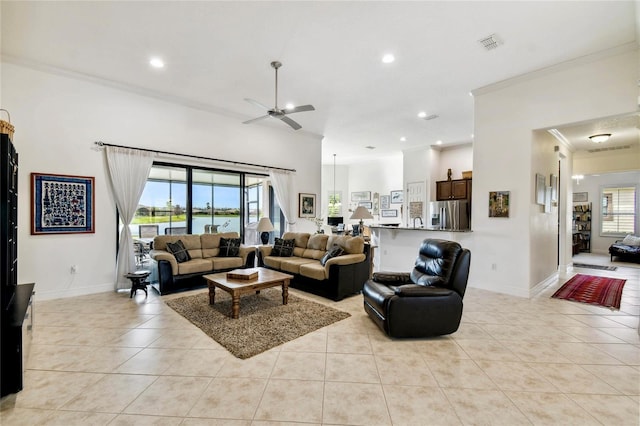 tiled living room featuring ceiling fan and ornamental molding