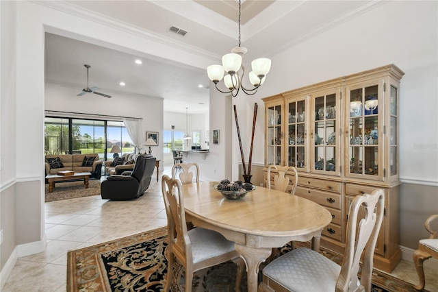 dining room with crown molding, light tile patterned flooring, and ceiling fan with notable chandelier