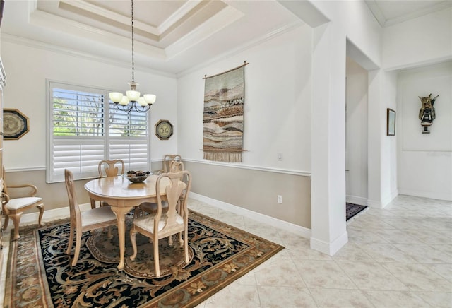 dining room featuring an inviting chandelier, light tile patterned floors, crown molding, and a tray ceiling