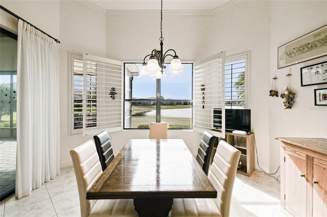 dining room featuring an inviting chandelier, ornamental molding, and light tile patterned flooring