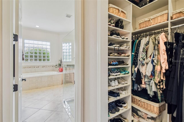 spacious closet featuring light tile patterned floors