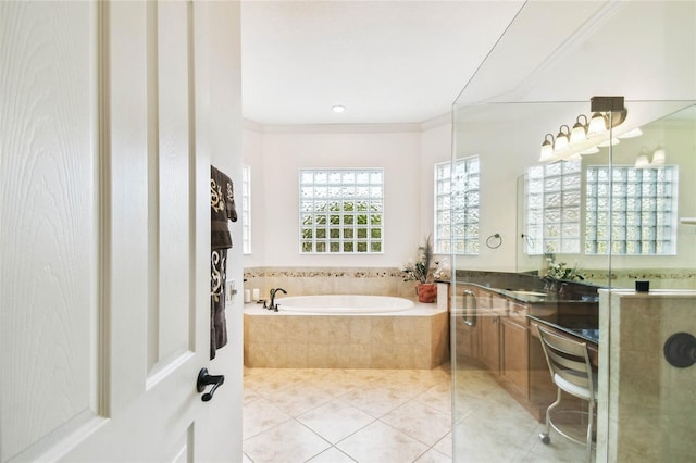 bathroom featuring tile patterned floors, vanity, ornamental molding, and tiled bath