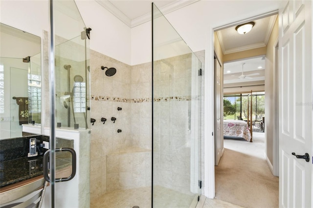 bathroom featuring ornamental molding, ceiling fan, and a shower with shower door