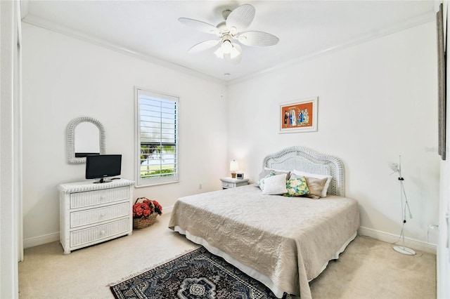 carpeted bedroom featuring ceiling fan and ornamental molding