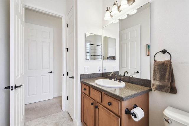 bathroom featuring tile patterned floors, vanity, and toilet