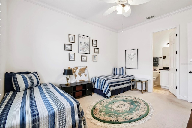 carpeted bedroom featuring ensuite bathroom, ceiling fan, and ornamental molding