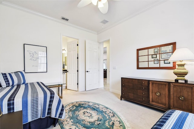 bedroom featuring ceiling fan, light colored carpet, ensuite bathroom, and crown molding