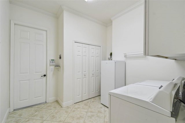 laundry room with light tile patterned floors, ornamental molding, and washing machine and clothes dryer