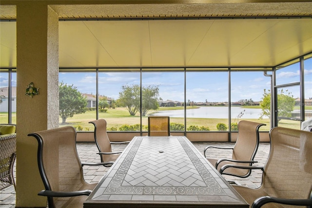 sunroom with a water view and a wealth of natural light