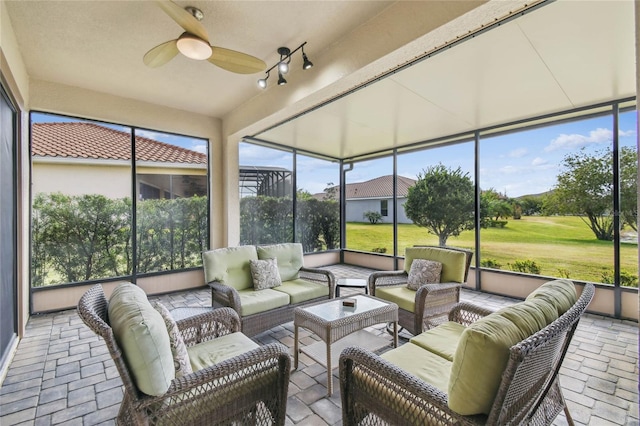 sunroom / solarium featuring ceiling fan