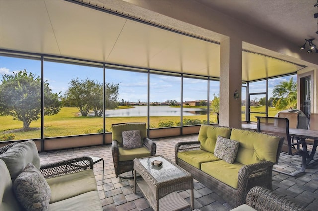 sunroom / solarium with a healthy amount of sunlight and a water view