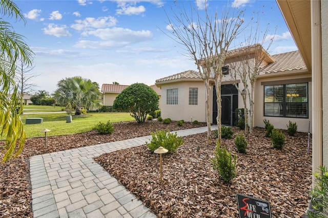 mediterranean / spanish home with a front yard