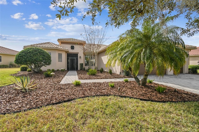 mediterranean / spanish-style house with a front yard