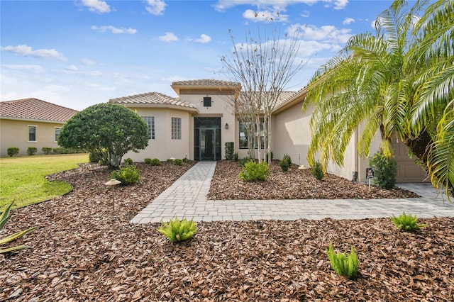 mediterranean / spanish house with a front lawn