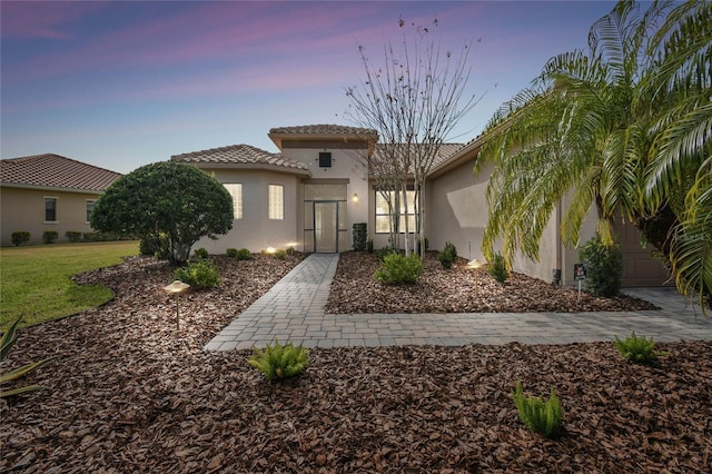 mediterranean / spanish house featuring a lawn