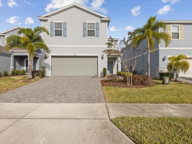 view of front of house with a garage and a front lawn