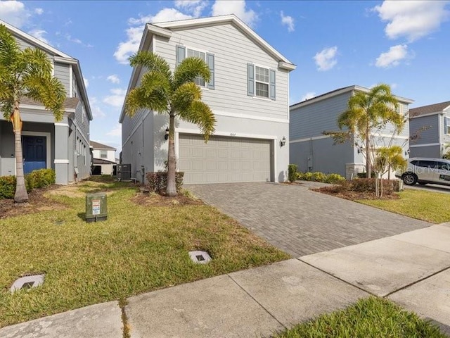 view of front of property featuring a garage, a front lawn, and central air condition unit