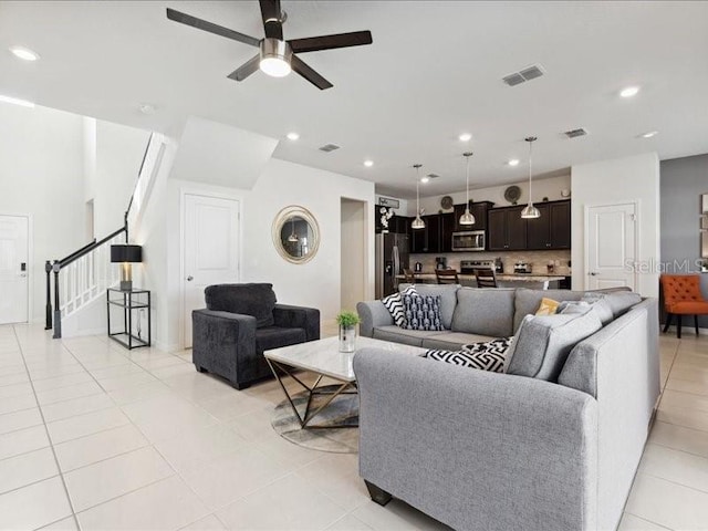 living room with ceiling fan and light tile patterned flooring