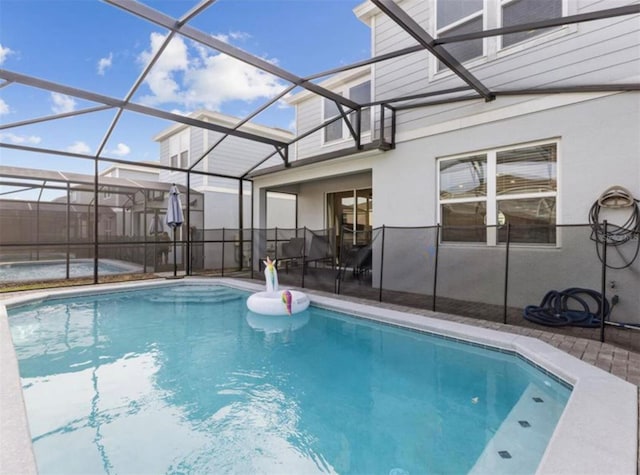 view of swimming pool featuring a patio and glass enclosure