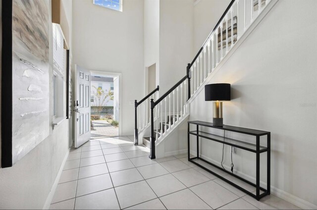 tiled entrance foyer featuring a high ceiling