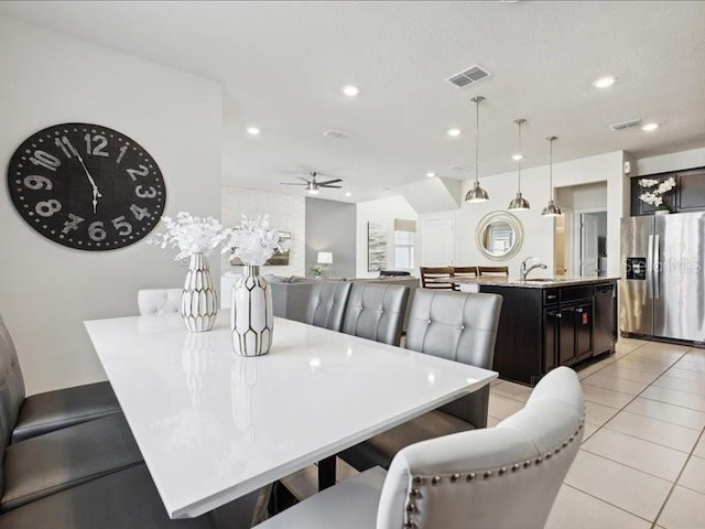 dining area with ceiling fan and light tile patterned floors