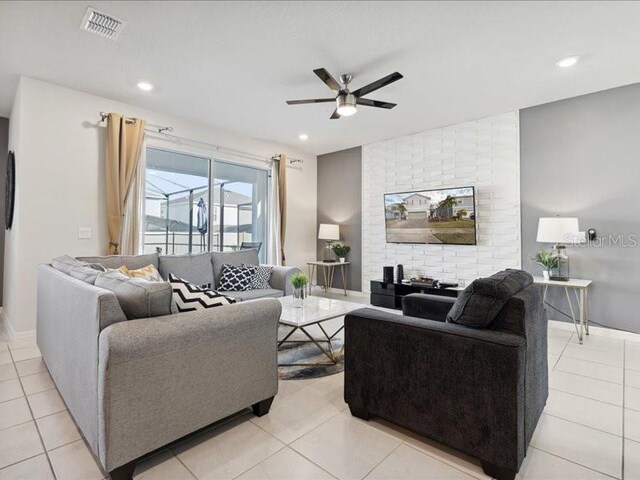 living room featuring ceiling fan and light tile patterned flooring