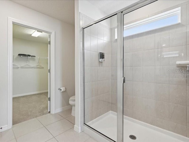 bathroom with toilet, an enclosed shower, and tile patterned flooring