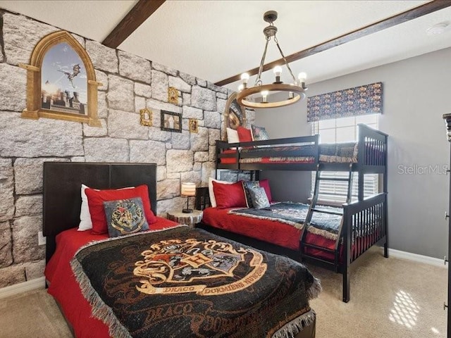 carpeted bedroom featuring an inviting chandelier, beam ceiling, and a fireplace