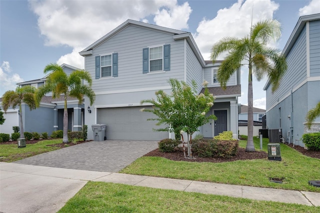 1607 Kona Ln, Davenport, FL 33897 - view of front facade featuring driveway, an attached garage, a front lawn, and stucco siding