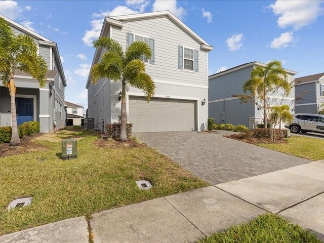 1607 Kona Ln, Davenport, FL 33897 - view of front of property with a garage, decorative driveway, a front lawn, and stucco siding