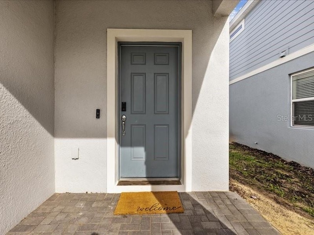 1607 Kona Ln, Davenport, FL 33897 - doorway to property with stucco siding