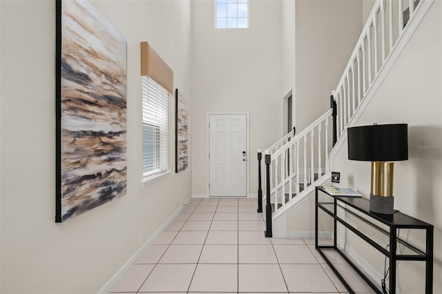 1607 Kona Ln, Davenport, FL 33897 - entrance foyer with a high ceiling, stairs, and light tile patterned flooring