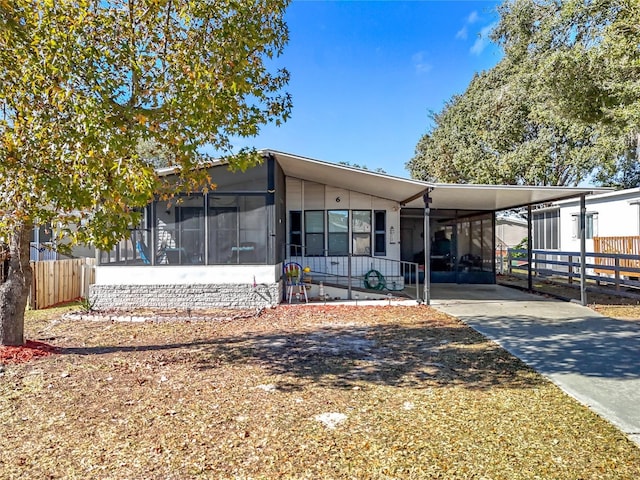 view of front of home featuring a sunroom and a carport