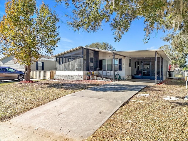 manufactured / mobile home with a carport and a sunroom