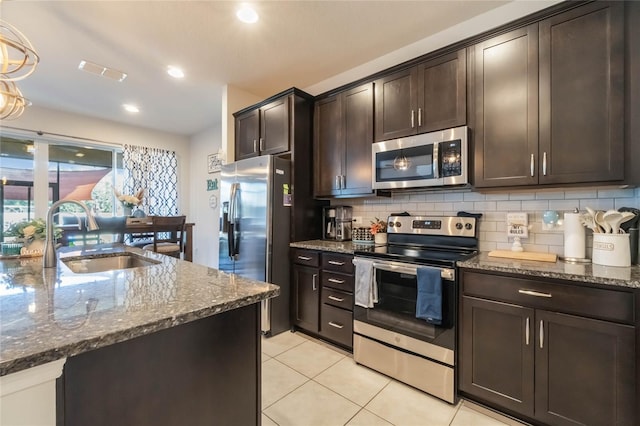 kitchen with dark brown cabinets, decorative light fixtures, and appliances with stainless steel finishes