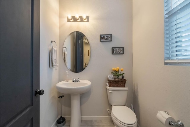 bathroom with tile patterned floors, toilet, and sink