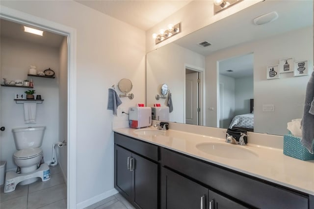 bathroom featuring tile patterned floors, vanity, and toilet