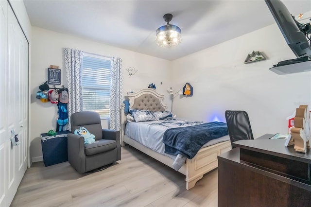 bedroom featuring a closet and light hardwood / wood-style flooring