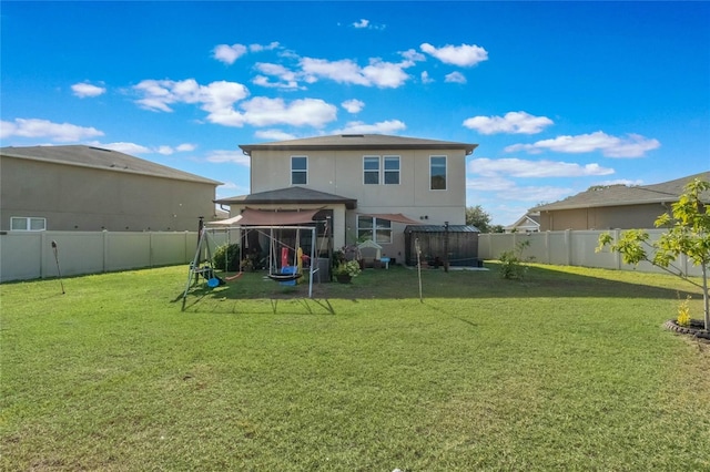 back of house with a lawn