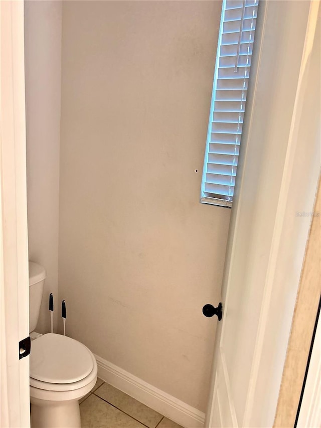 bathroom featuring tile patterned floors and toilet