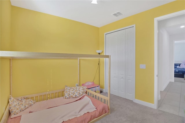 carpeted bedroom with a closet