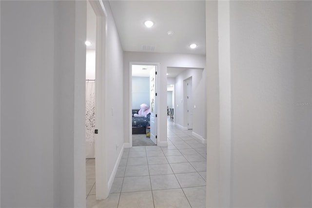 hall with light tile patterned flooring