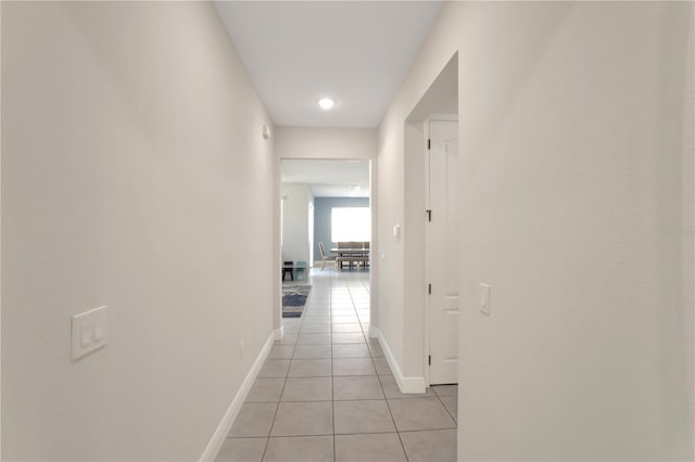 hall with light tile patterned floors