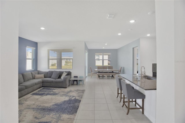 tiled living room featuring sink